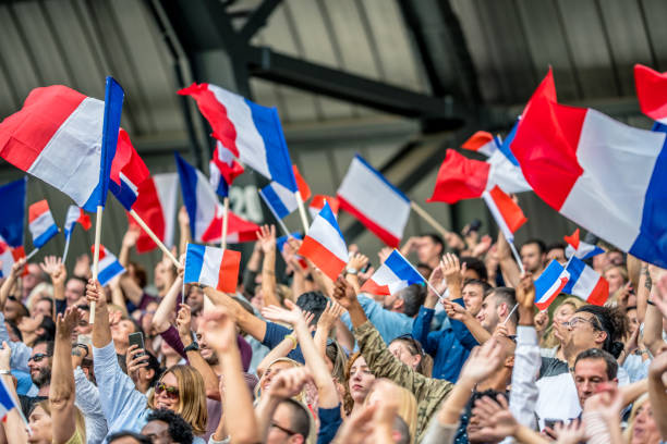 istock French people waving French flags 1127582228