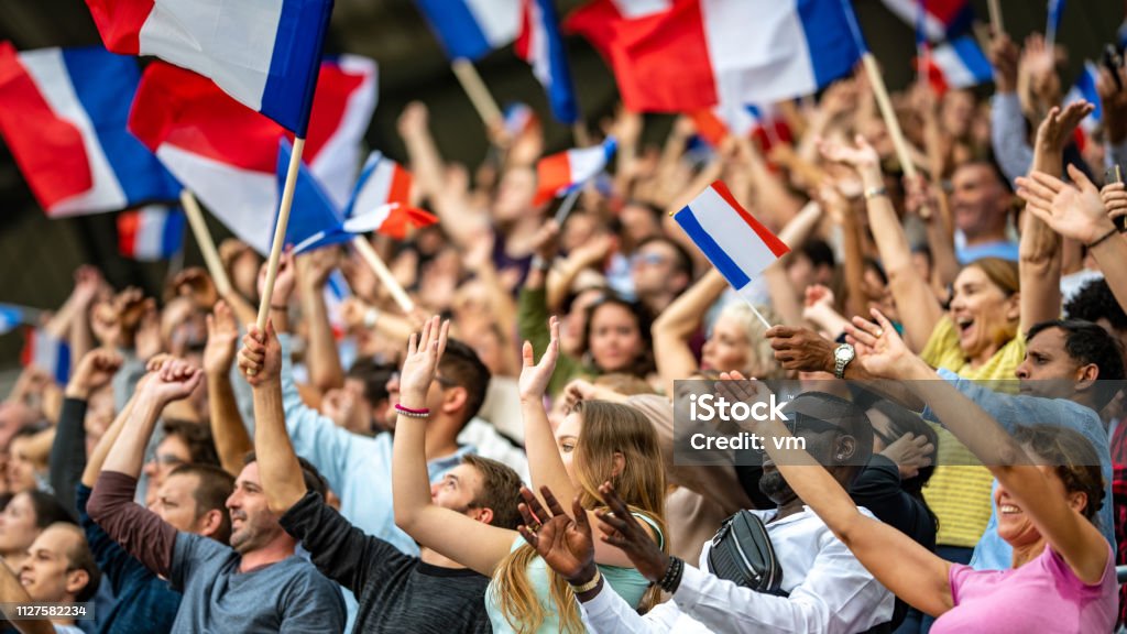 Waving French flags Crowds of French supporters waving their flags on a stadium. France Stock Photo