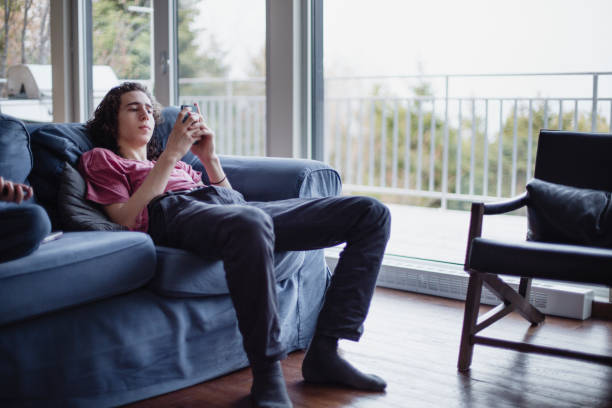 Teenage boy using his smart phone stock photo
