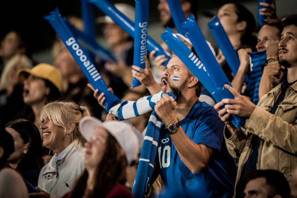 istock Cheering fans in blue jerseys 1127582545