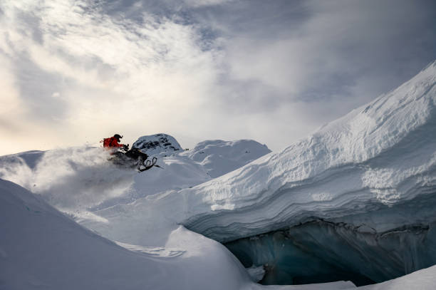 istock Skilled snowmobiler doing a jump in the mountains 1127582832