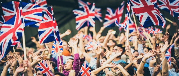 istock People on a stadium waving Great Britain flags 1127582907