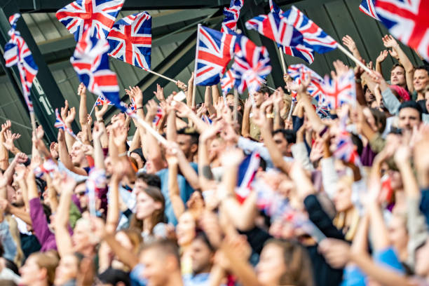 istock Great Britain fans waving flags 1127582914