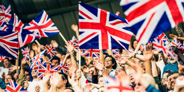 istock Great Britain fans waving flags 1127582916