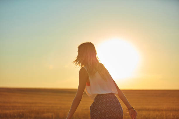 istock Cute young woman jumping in a wheat field. 1127583686