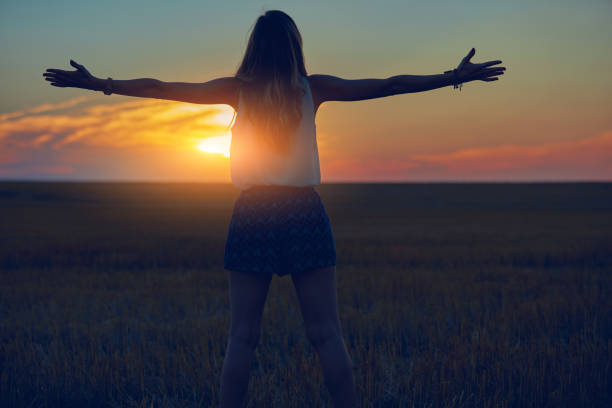 istock Cute young woman jumping in a wheat field. 1127584131