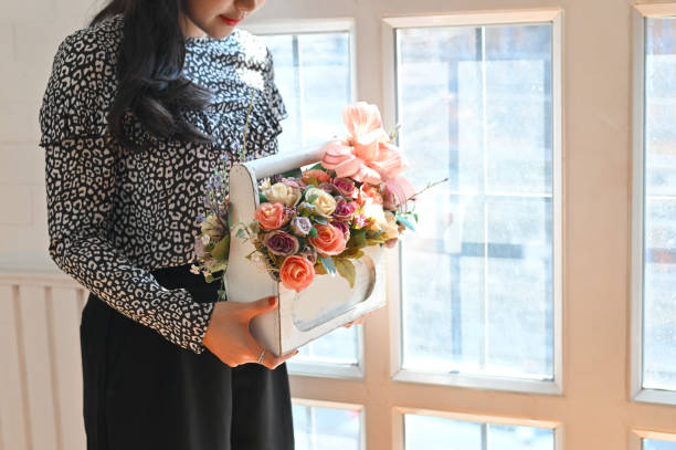Woman giving a flower basket.
