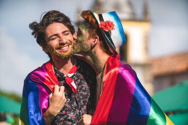 istock Homosexual couple wrapped in rainbow flag 1127589522
