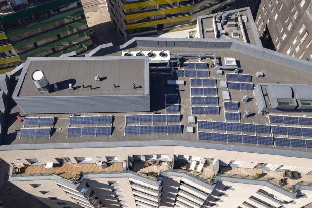 Solar panels on the roof Solar panels on the roof of the multi-family houses, aerial view solar panels on the roof of building in a city stock pictures, royalty-free photos & images