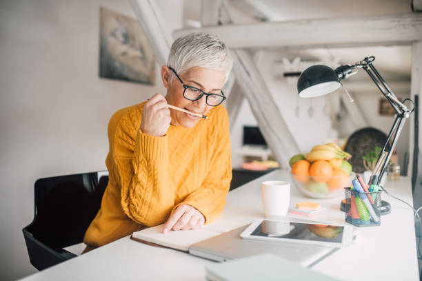 istock Woman biting pencil top 1127590492