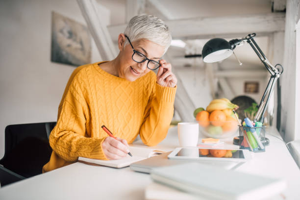 istock Mature woman writing 1127591029