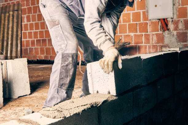 istock Real construction worker bricklaying the wall indoors. 1127591250