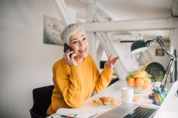 istock Mature woman using phone 1127591253