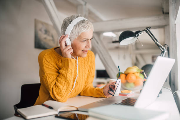 istock Woman holding headphones 1127591710