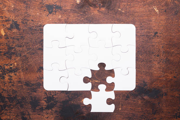 istock Jigsaw Puzzle with missing piece on old wooden background Top view 1127595822