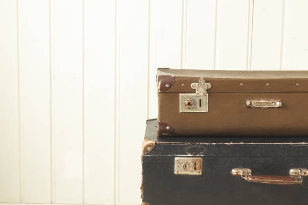 istock Two old retro suitcases White wooden background Vintage tinting Copy space 1127596504