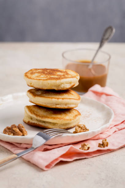 istock Pancakes with walnuts on plate with fork and napkin 1127597543