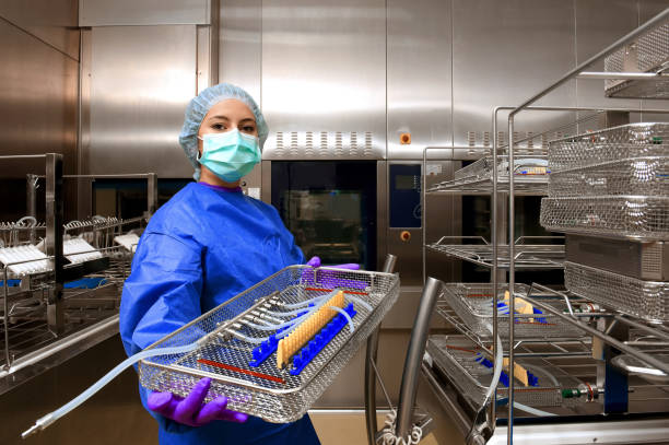 Medical Hygiene Technician A young woman works in a hospital as a 
medical hygiene technician. She is dressed 
in special medical hygiene clothing and 
carries out hygiene disinfecting and logistic
tasks. cleanroom photos stock pictures, royalty-free photos & images