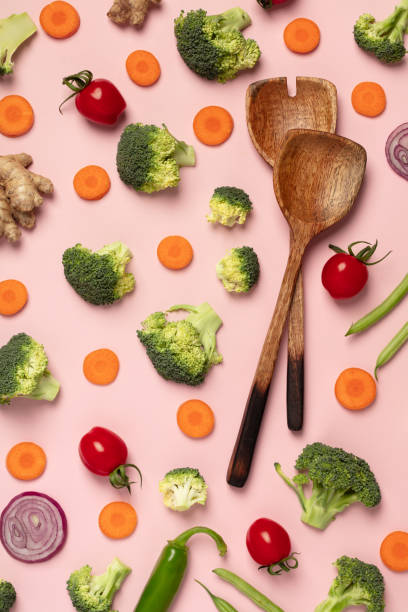 istock Colorful pattern of tomatoes, broccoli, carrots, ginger and onion on a pink background 1127599094
