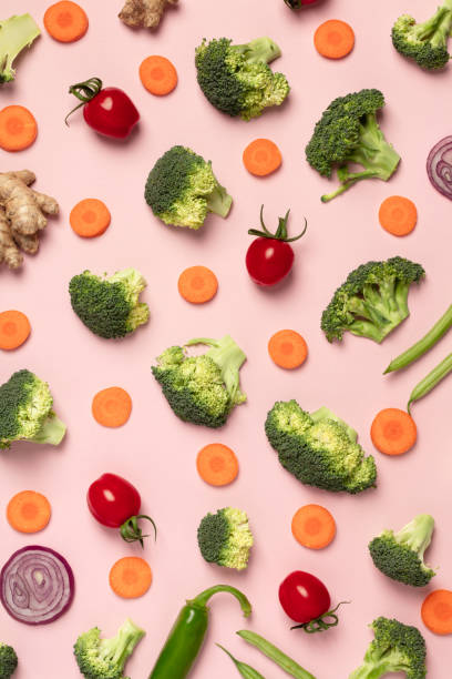 istock Colorful pattern of tomatoes, broccoli, carrots, ginger and onion on a pink background 1127599102