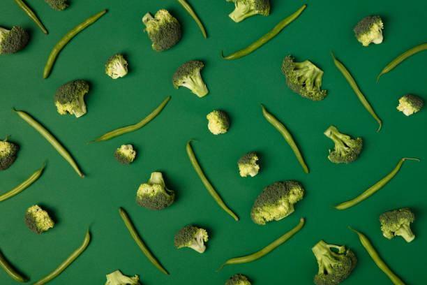 istock Colorful pattern of Broccoli and green beans on a green background. 1127599113