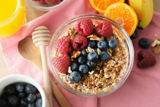 istock Cereal, muesli and various delicious fruit, berries for breakfast. healthy, energy breakfast, wooden table. 1127600143