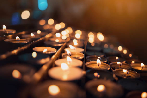 istock Many blazing candles, shining fire candles in the temple. 1127601172
