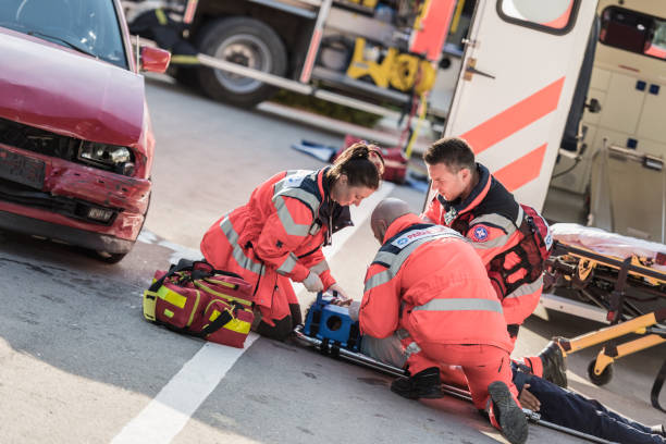 Rescue Team Helping Victim Of Car Crash Rescue Team Helping Victim Of Car Crash brain damage stock pictures, royalty-free photos & images