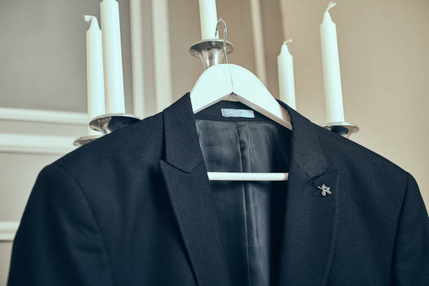 istock men's suit hanging in the room 1127601451