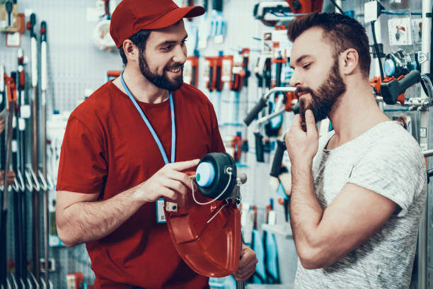 istock Salesman is Showing New Lawn Mower to Client 1127602087