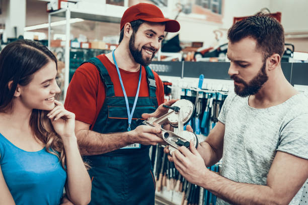 istock Salesmen is Showing Device with Suckers to Clients 1127602097