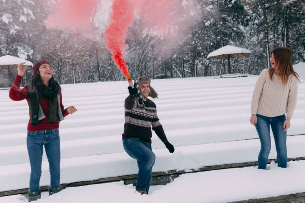 istock Friends having fun with smoke bomb and dancing 1127602854