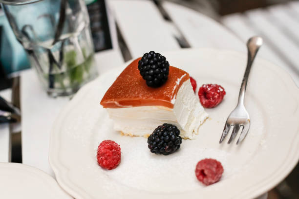 istock Cheese cake with caramel and berries, raspberry and black currant 1127602888