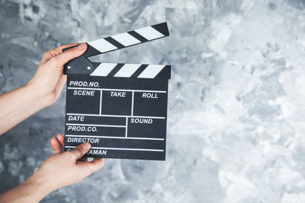 istock woman hand  movie clapper 1127604358