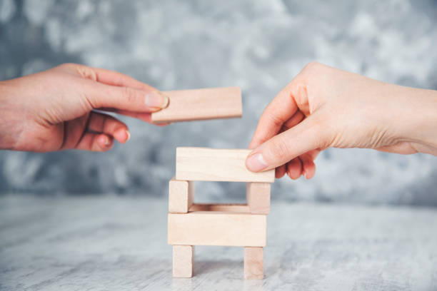 istock team  hand wooden cubes on table 1127604365