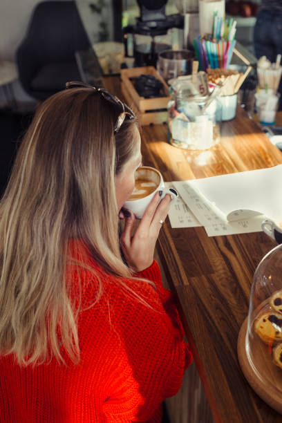 istock Happy woman enjoying some coffee in a cafeteria 1127605030