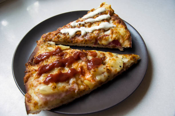 istock Two pieces of pizza on a plate 1127605129