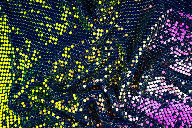 istock Abstract background with gold, green and purple sequins on the fabric. 1127607241