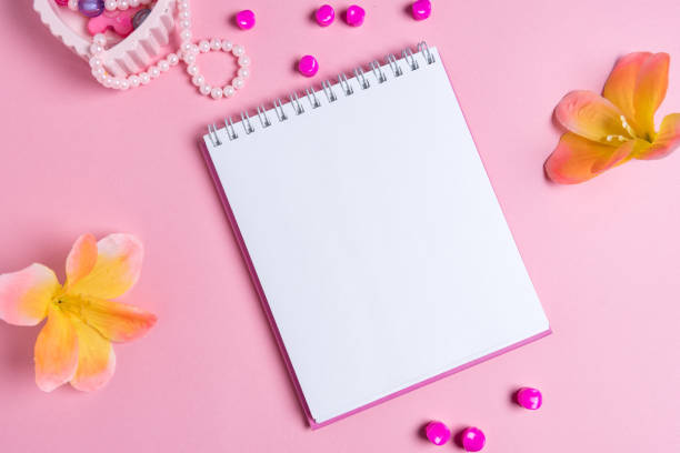 istock jotter on a pink background with women's ornaments. Valentine's Day. 1127609248