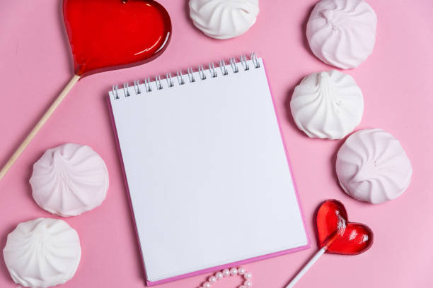 istock jotter on a pink background with women's ornaments. Valentine's Day. 1127609266