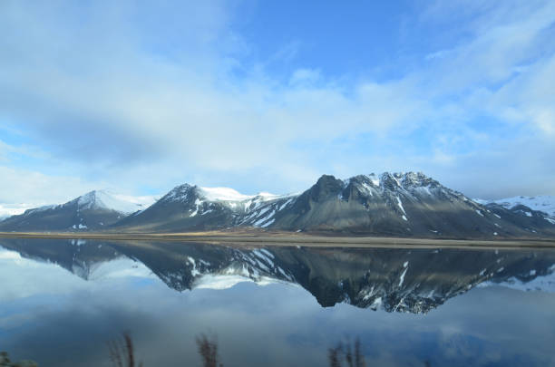 Iceland's mountains reflecting in a large pool of water.