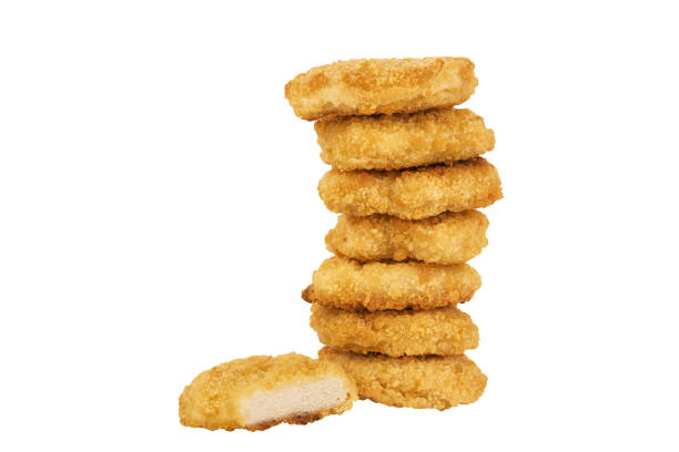 istock Pile of chicken nuggets isolated on a white background. 1127610559