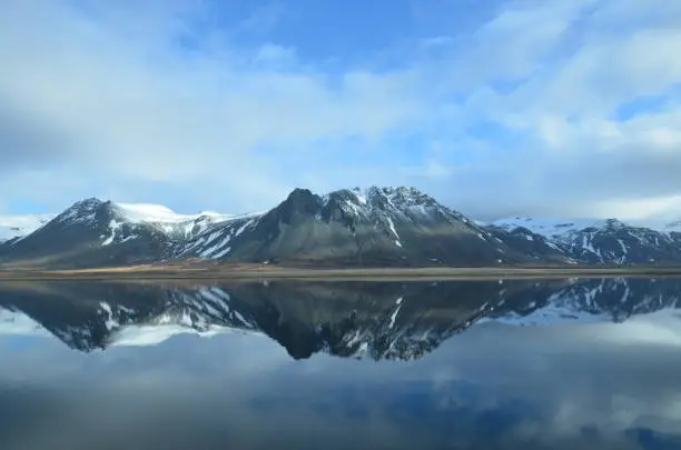 Iceland's mountains reflecting in water.
