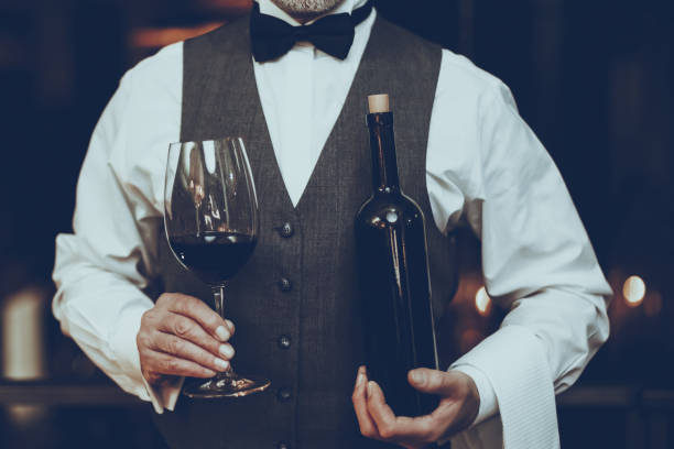 istock Sommelier is Holding Wine in Glass and Bottle 1127611015