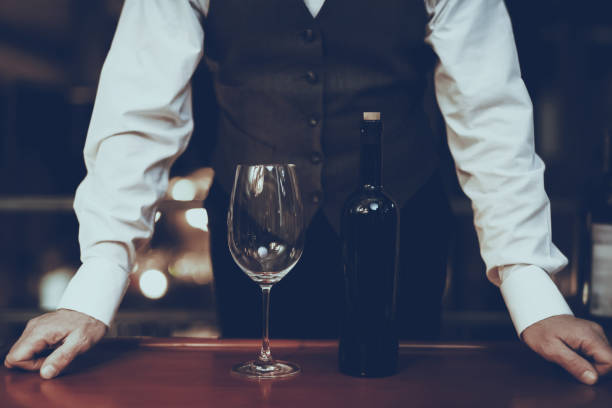 istock Sommelier Standing at Table with Glass and Bottle 1127611031