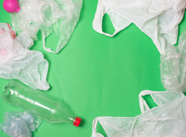 plastic bags and bottles on a green background with space for text.
ecology mockup - tailings container environment pollution imagens e fotografias de stock