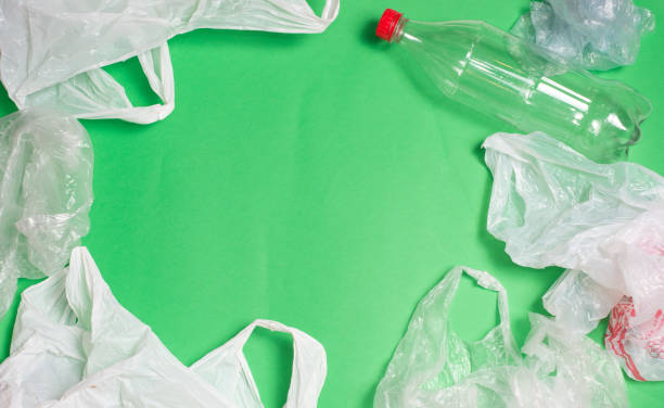 plastic bags and bottles on a green background with space for text.
ecology mockup - tailings container environment pollution imagens e fotografias de stock