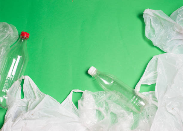 plastic bags and bottles on a green background with space for text.
ecology mockup - tailings container environment pollution imagens e fotografias de stock