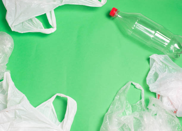 plastic bags and bottles on a green background with space for text.
ecology mockup - tailings container environment pollution imagens e fotografias de stock