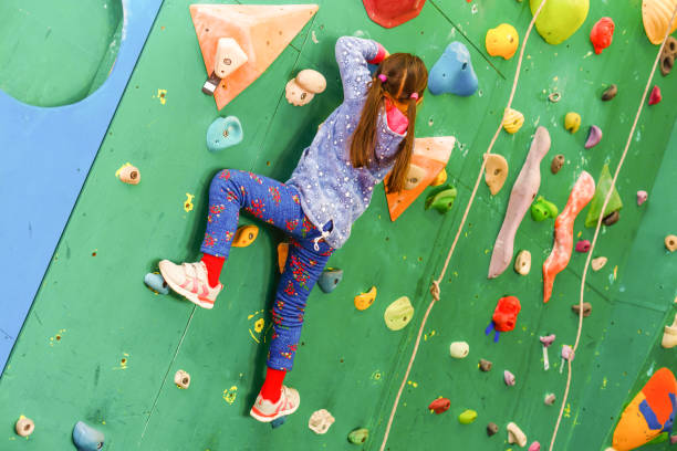 istock Teenager climbing a rock wall 1127611961